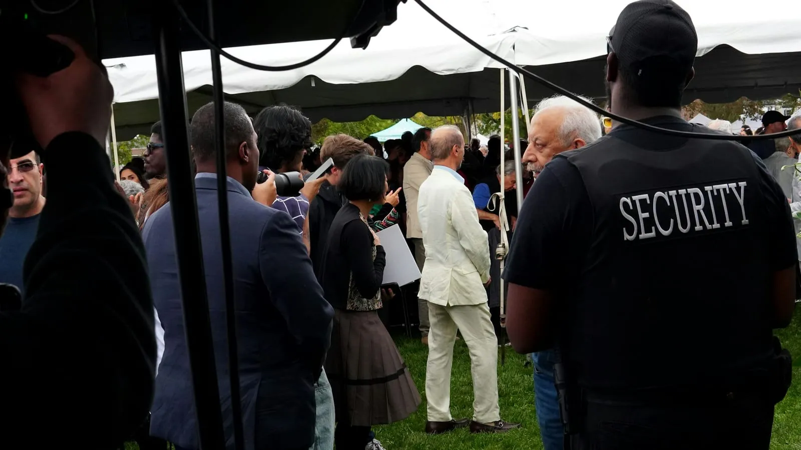 Staff and attendees at a marquee during an outdoor public event.