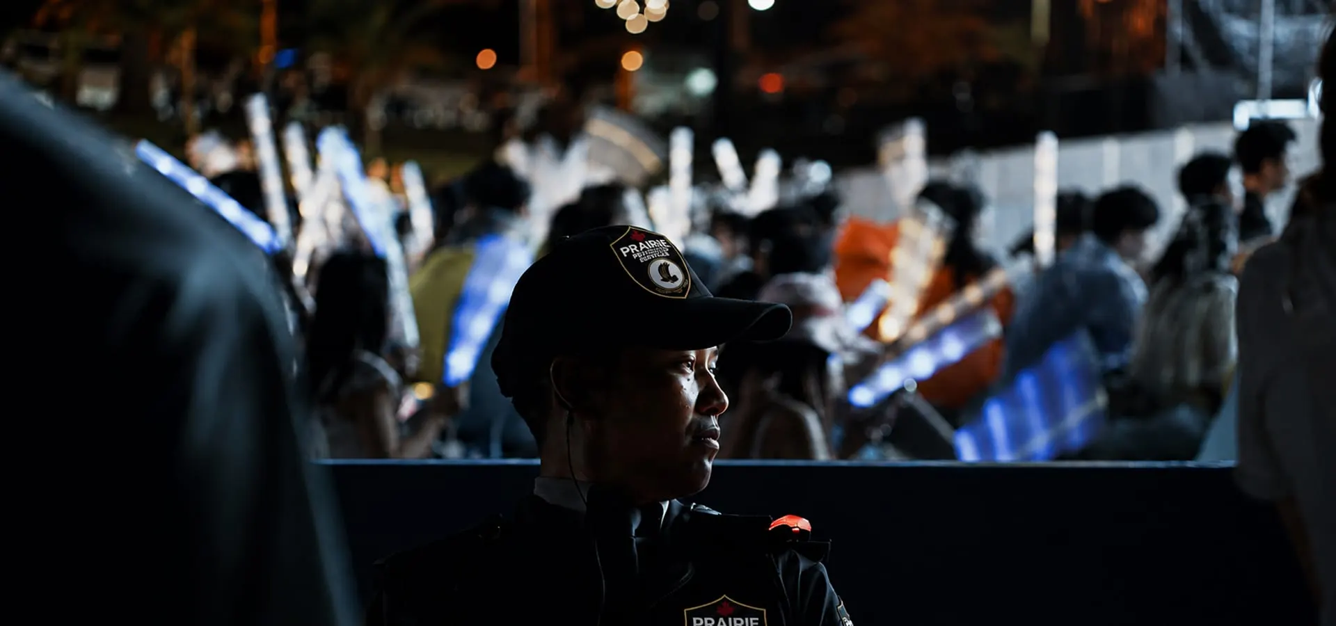 A Prairie Protection Services officer on duty at a night-time public event.