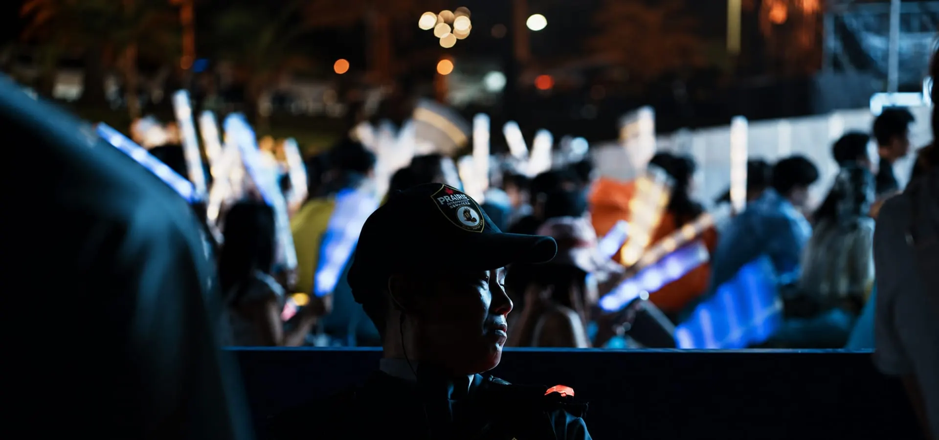 A Prairie Protection Services officer on duty at a night-time public event.